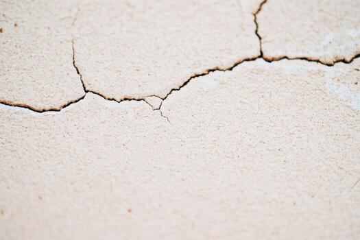 Cracked surface revealing texture and details in dry environment photo