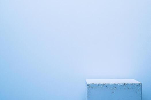 Minimalist white block against soft blue wall creates serene atmosphere photo
