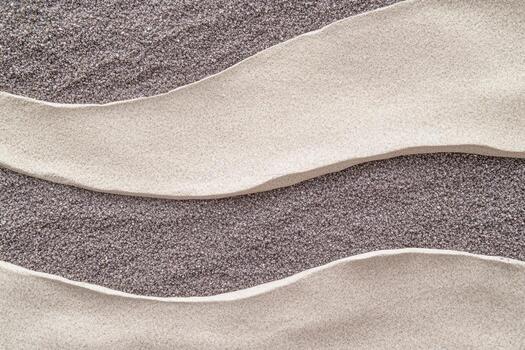 Textured layers of sand with smooth curves create a natural pattern photo