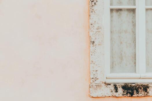 Elegant window detail against a soft peach wall in a serene setting photo