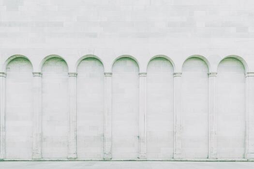 Minimalist architecture featuring uniform arches on a white wall photo