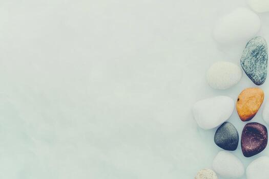 Colorful pebbles arranged on a light surface in a serene setting photo