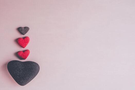 Heart-shaped stones in a gradient pattern on a soft backdrop photo
