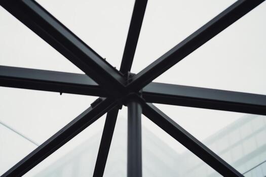 Unique architectural view of metal structure under cloudy sky photo