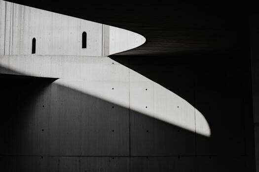 Shadows play on minimalist concrete structure highlighting architectural form photo