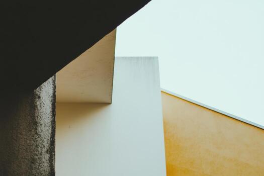 Unique architectural lines and angles under a clear sky in an urban setting photo