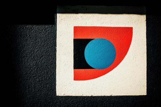 Colorful geometric mural on a textured wall in an urban setting photo