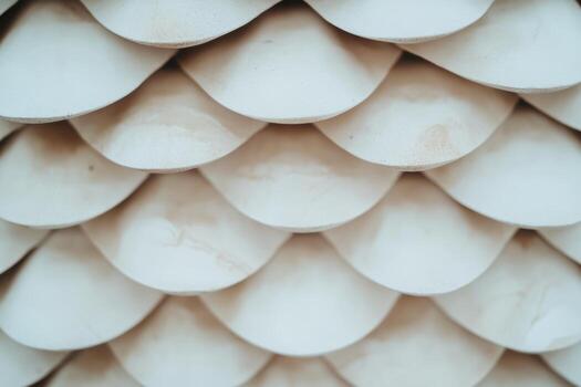 Wooden shingles create a layered texture in natural light at a construction site photo