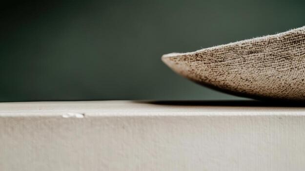 Texture of a woven basket resting on a beige surface in soft lighting photo