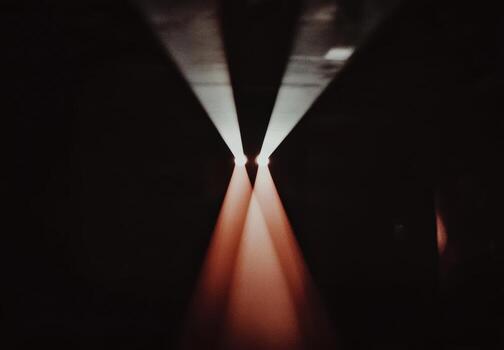 Light beams converge in a dark space during an artistic display photo