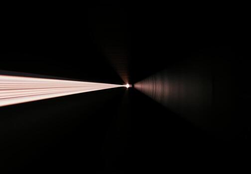 Light beam extending through dark tunnel during nighttime exploration photo
