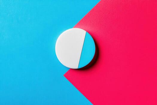 Colorful round object split between blue and pink background photo