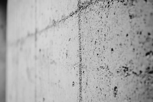 Close-up view of a textured concrete wall in monochrome tones photo