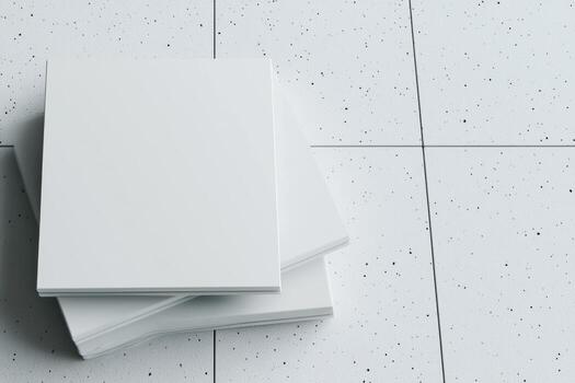 Stack of white tiles on a speckled floor in a modern interior setting photo