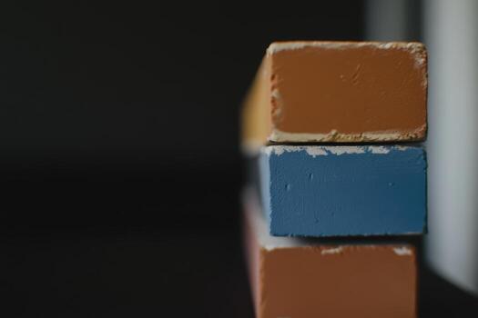 Colorful blocks stacked neatly with a dark background in a close-up shot photo
