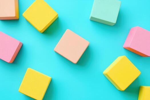 Colorful soft blocks arranged on a vibrant turquoise background photo
