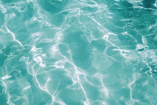 Calm turquoise water reflects sunlight in a serene pool setting photo