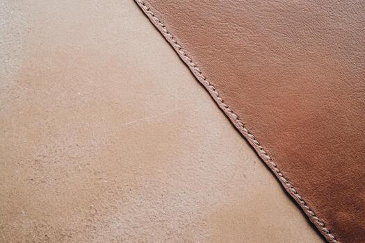 Leather texture close-up highlighting color variations and stitching detail photo