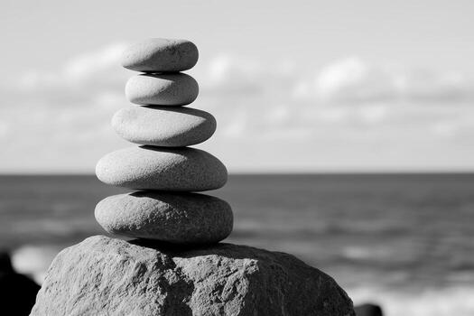 Balanced stones create a serene figure against the ocean backdrop photo
