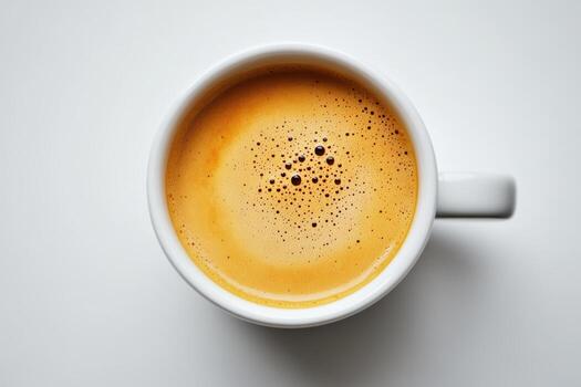 Freshly brewed coffee in a white mug with a rich foam layer on top photo