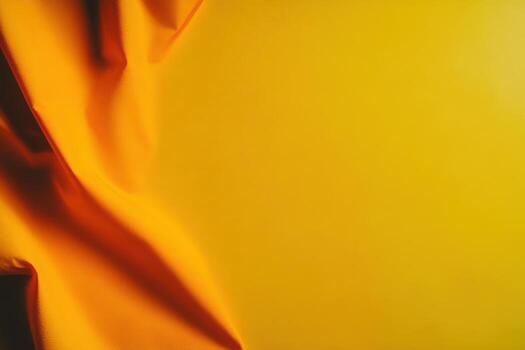 Yellow fabric draped against a smooth backdrop for artistic contrast photo