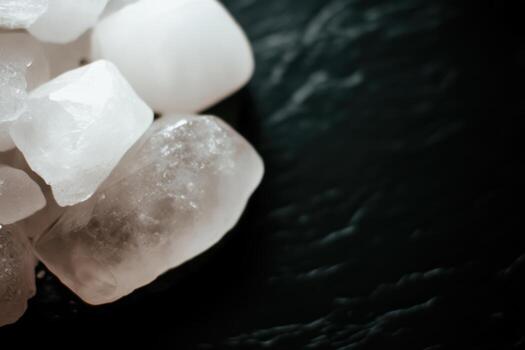 Natural crystals resting on a dark stone surface showcasing unique textures photo