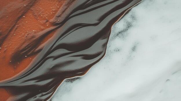 Swirling patterns of dark liquid on a contrasting light surface photo