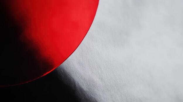 Red circular shape contrasts with light background in modern art composition photo