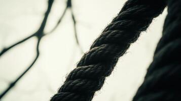 Close-up view of textured rope amidst blurred natural background photo
