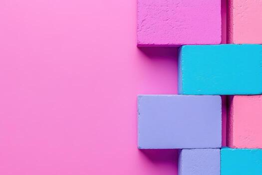 Colorful building blocks arranged on a pink background creating a playful design photo
