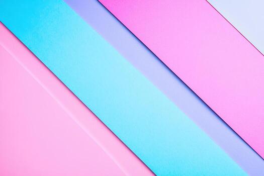 Colorful paper sheets arranged in vibrant diagonal patterns on a background photo
