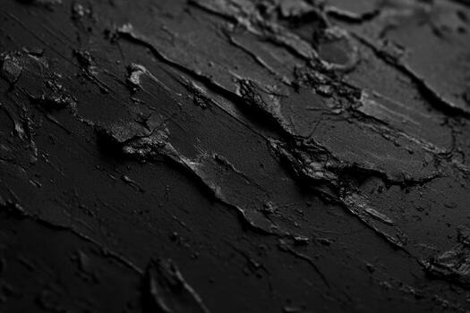 Textured black surface with intricate patterns created by layering material photo