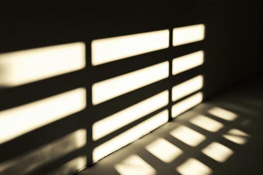 Shadows cast by window blinds create patterns on the wall in bright light photo