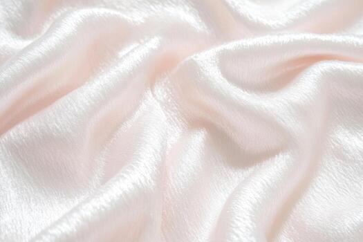 Soft pink satin fabric draped elegantly with subtle sheen and texture photo