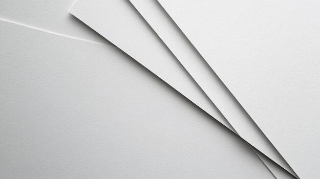 White sheets of paper arranged at an angle on a flat surface photo