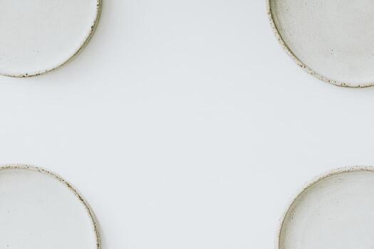 Empty plates arranged neatly on a white table ready for a meal photo