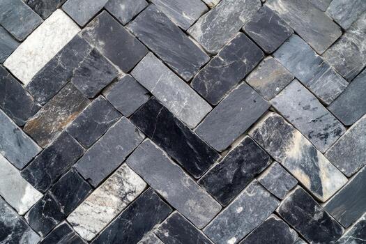 Detailed pattern of slate stone tiles arranged in a herringbone design photo