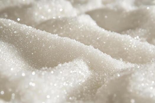 Close-up of sparkling white sugar crystals on a soft surface photo