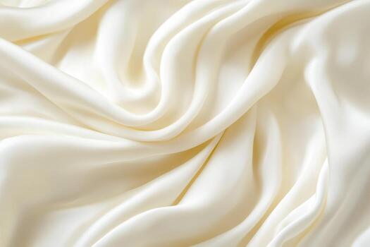 Soft ivory silk fabric draping elegantly on a smooth surface photo
