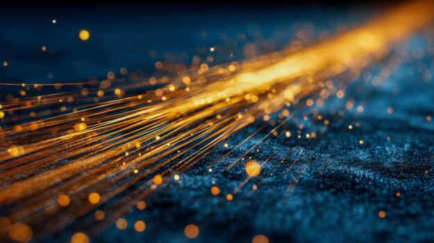 Golden light streaks and glowing particles create an abstract dynamic flow over a textured dark surface with blurred illuminated bokeh effects in the background photo