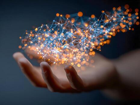 Human hand holding a glowing digital network composed of interconnected points and lines representing abstract technology and data connectivity in blue and orange colors photo