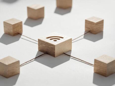 Wooden blocks connected with strings symbolizing wireless network connectivity and communication technology in a minimalist design concept on a white surface photo