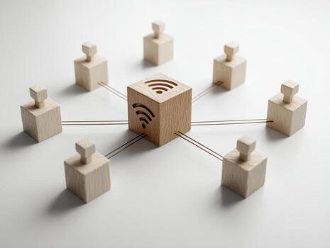 Wooden blocks connected by strings representing a network with a central block featuring wireless signal symbols symbolizing connectivity and communication systems photo