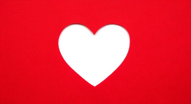A Simple White Heart Cutout on a Vibrant Red Background. photo