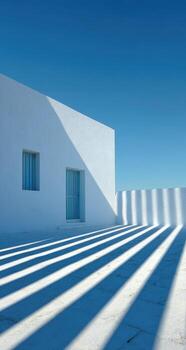A white building with shadows on the ground photo