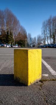 A yellow block in a parking lot photo