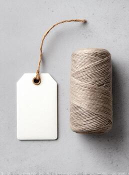 A spool of thread and a tag on a gray background photo