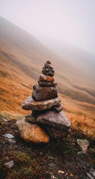 A stack of rocks on top of a hill photo