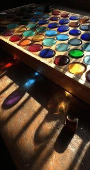 A wooden table with a colorful glass board on it photo