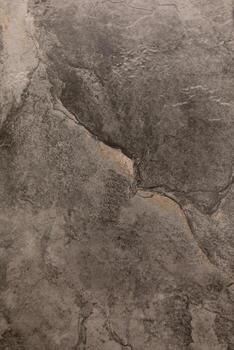 Textured gray stone surface with visible cracks and natural patterns for design and architecture projects photo